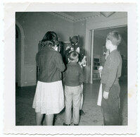Children Standing with Masked Person