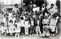 Philip Simmons and a group of children in front of his workshop.