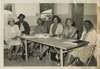 Group photo of women around a table