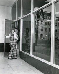 Young woman entering front door of Main Library