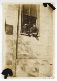 Photo of Edwin Pearlstine and Another Man Leaning out a Window