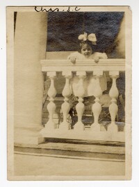 Photo of Young Mary Pearlstine Leaning on a Porch Railing
