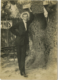 Man Leaning Against Tree
