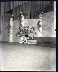 A Woman and Child Stepping Off a Stage