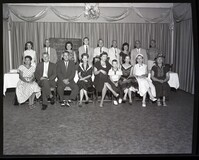 Group Photo of People in Front of Chalkboard and Curtains
