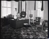 Bishop John Russell and Another Man Posing in Catholic Banner Office