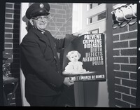 A Firefighter Posing with March of Dimes Poster