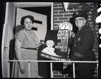 Firefighter and Woman Posing with March of Dimes Poster