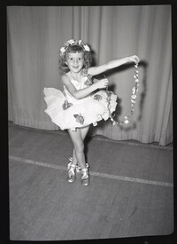 Child Dancer Posing in Costume with Flower Chain