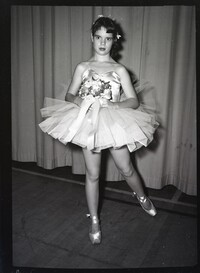 Child Dancer Posing with Flowers in Costume