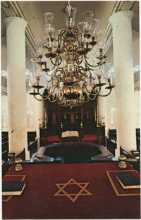 Interior of Mikve Israel-Emanuel Synagogue, dedicated in 1732, oldest in continuous use in Western Hemisphere. View is towards Hechal containing 18 scrolls and is taken from Tebah (reading platform) in center of sandcovered floor.