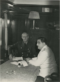 Military officials conversing on a train, Photograph 1