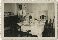 Photograph of a Man Setting a Dining Room Table