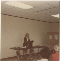 Photograph of a Women Speaking in Front of a Group