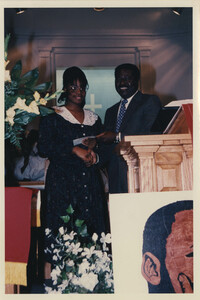 Photograph of Two People Behind a Podium