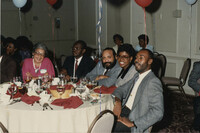 Photograph of MaeDe Brown and Others Seated Around a Table