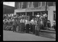 Group of participants in the 40 and 8 parade in front of Fordham Hardware