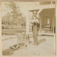 Man with dead opossums and raccoon