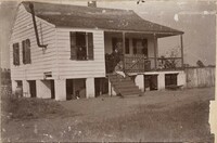 One of the dependencies at Halls Island; Family group on steps and in window