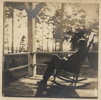 Man sitting in rocking chair on porch