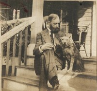 Christopher Donner with dog on steps to unidentified house
