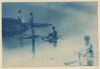 Children playing in the water watched by woman
